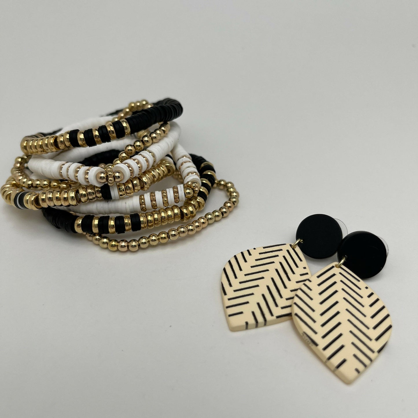 Classic colors with a Bohemian twist-7 piece white, black, and gold clay bead bracelet set
